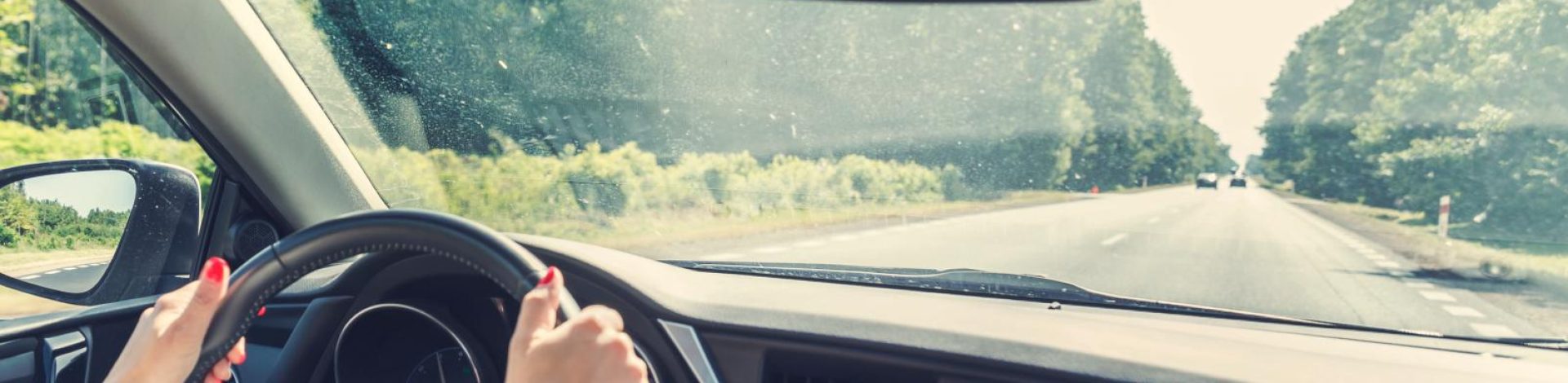 Woman driving car with windshield engineering design my NIW recipient with help of Immigration Attorney, Jason Crofts.